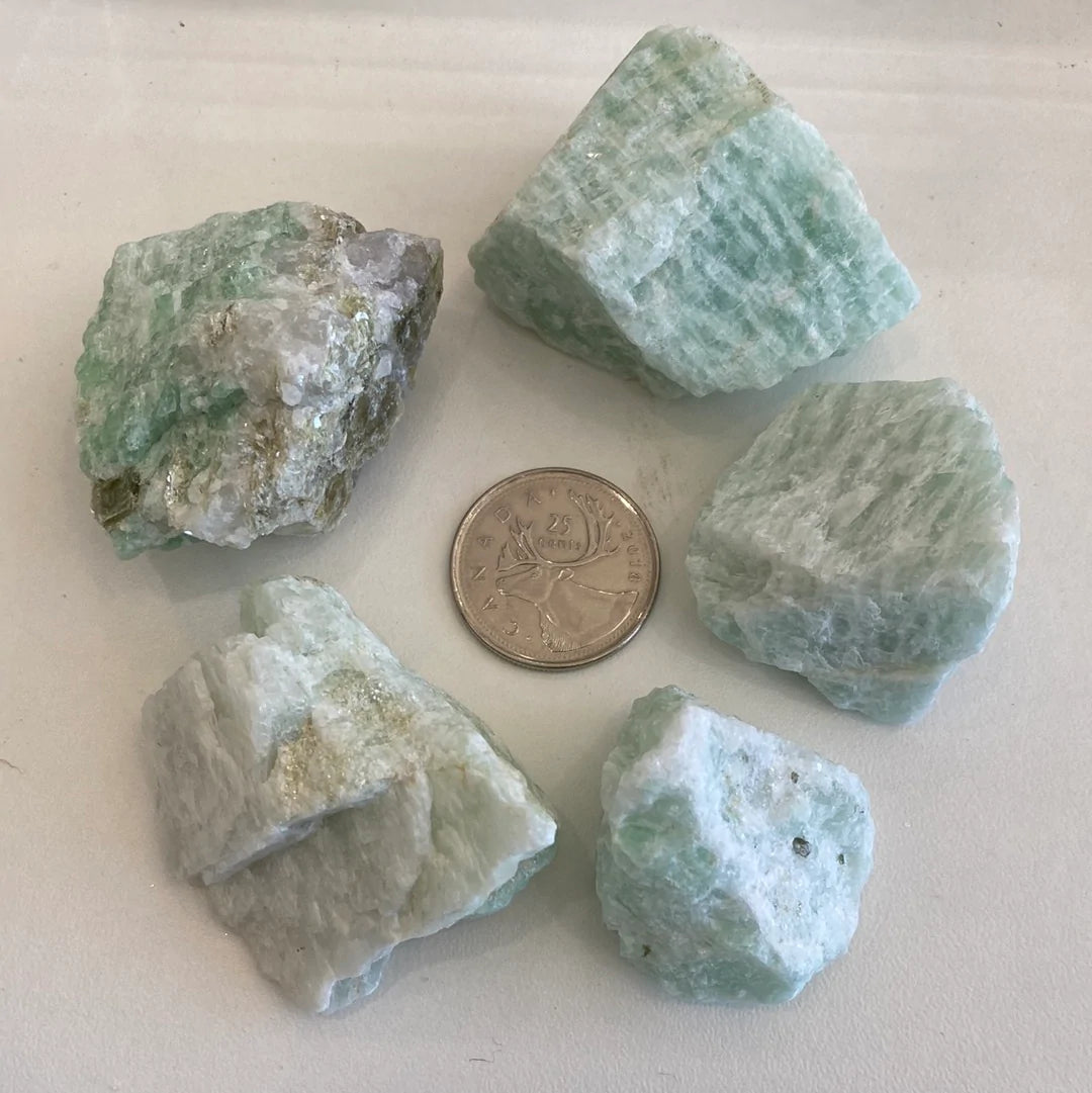 A collection of Amazonite Rough Cut stones showcasing unique shapes and pale aqua colors, perfect for jewelry and ceramics.