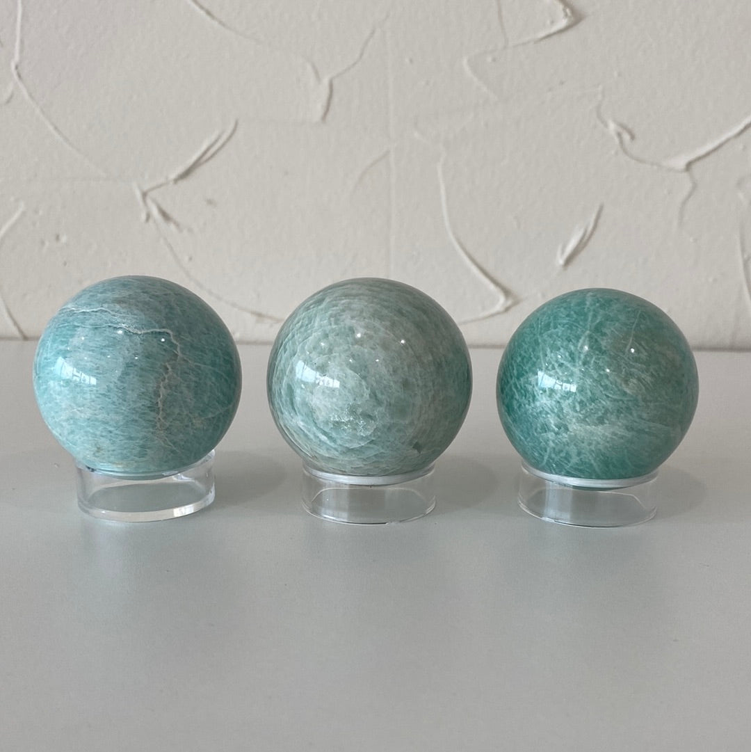 High-quality 1.5-inch Amazonite spheres showcasing their pale aqua color and smooth surface.