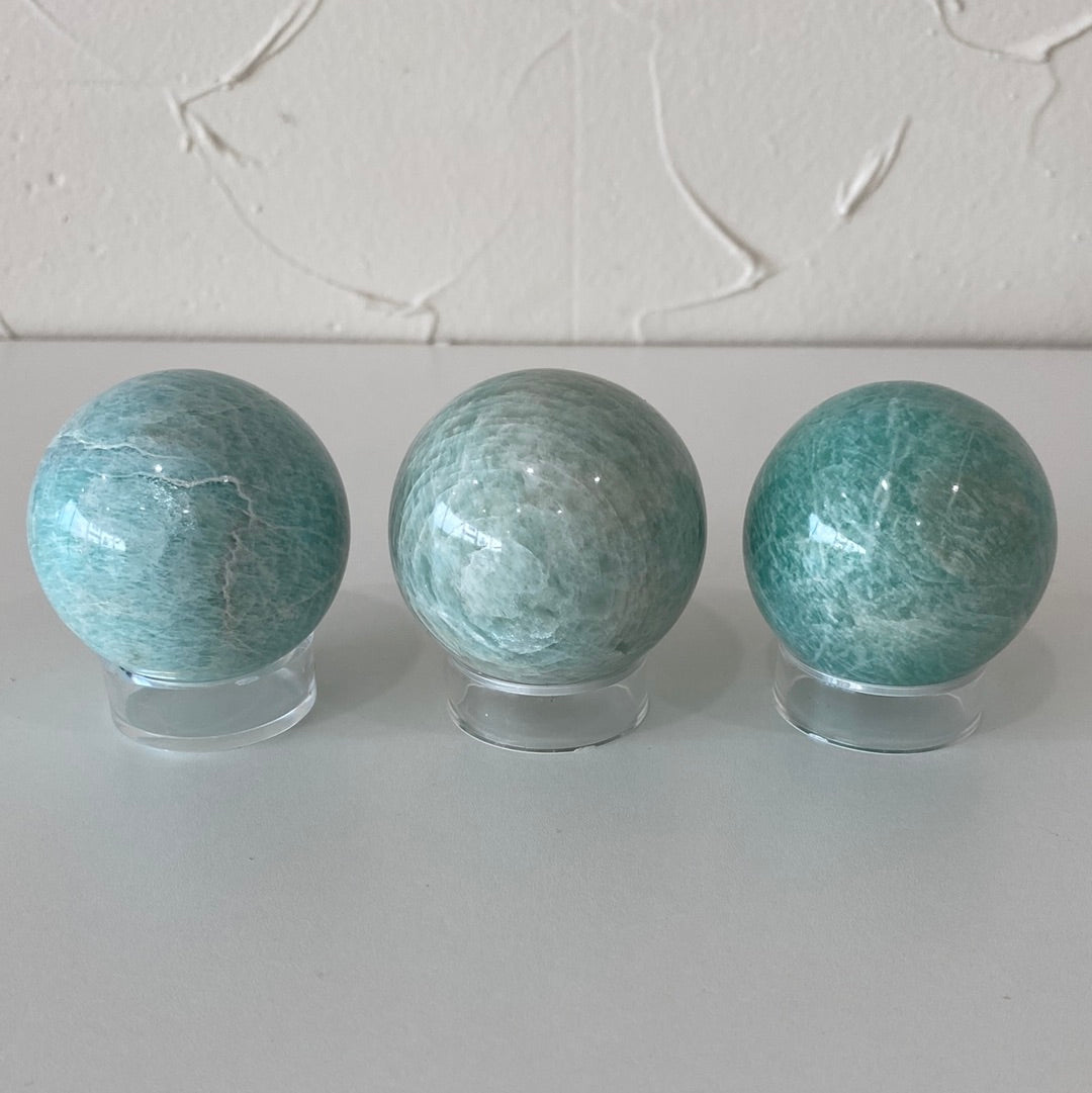 High-quality 1.5-inch Amazonite spheres showcasing their pale aqua color and smooth surface.