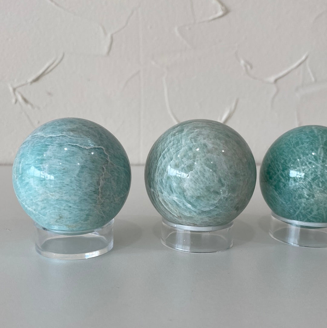 High-quality 1.5-inch Amazonite spheres showcasing their pale aqua color and smooth surface.