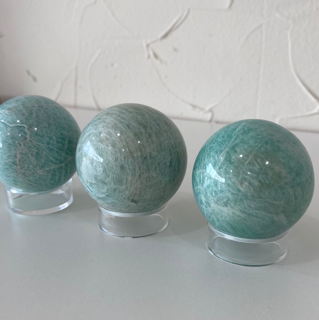 High-quality 1.5-inch Amazonite spheres showcasing their pale aqua color and smooth surface.