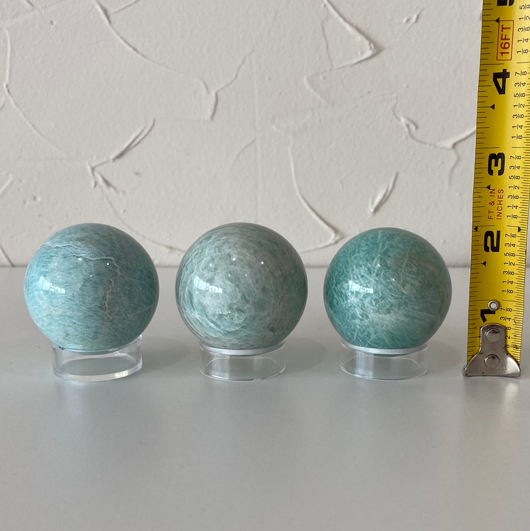 High-quality 1.5-inch Amazonite spheres showcasing their pale aqua color and smooth surface.