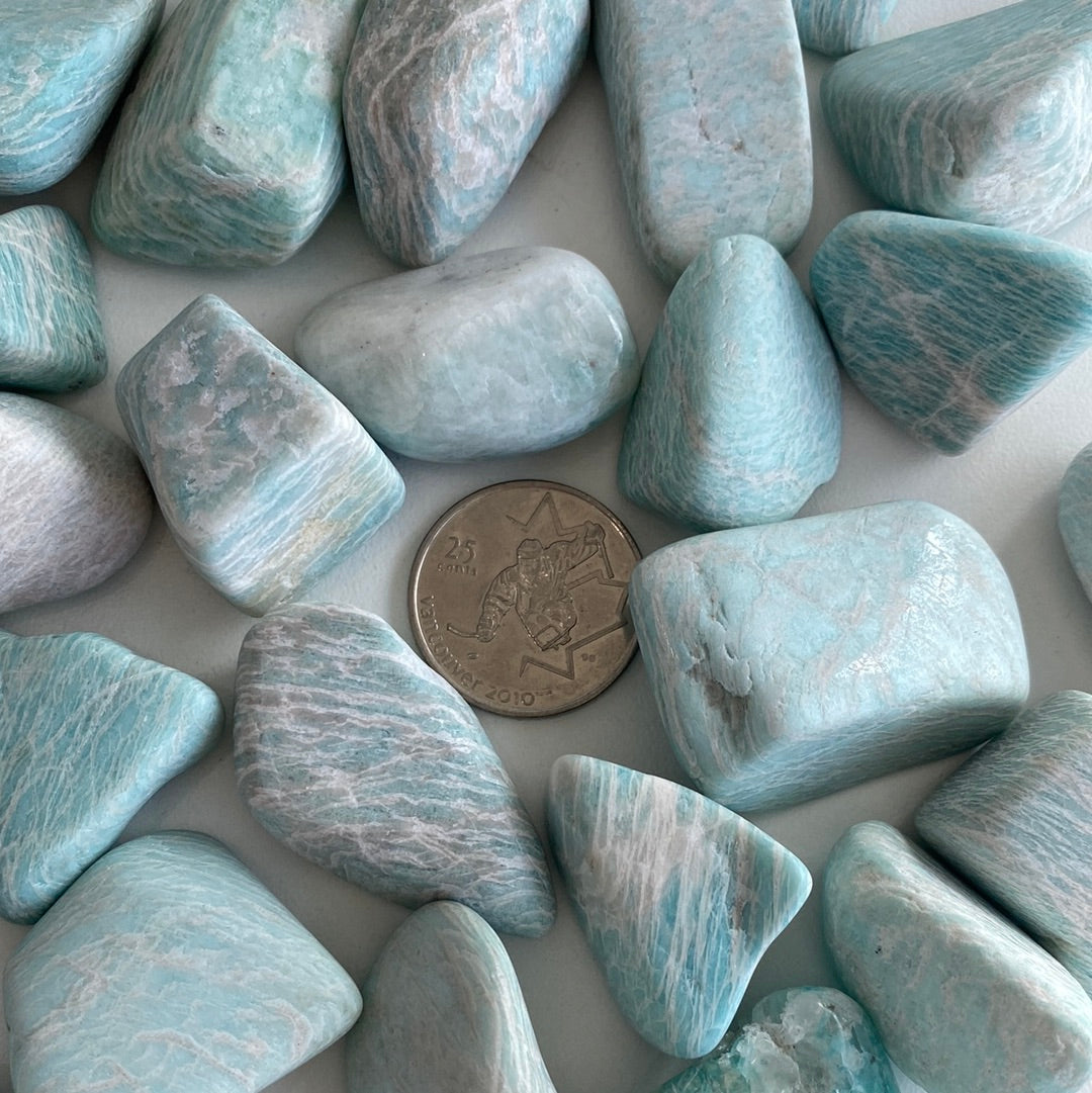 A collection of Amazonite Tumbled stones showcasing their unique pale aqua colors and smooth surfaces, perfect for healing and jewelry.