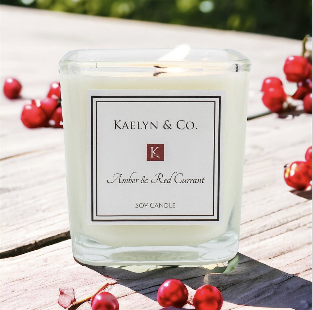 Amber & Red Currant Small Cube Candle in elegant packaging, showcasing its rich color and sophisticated design.