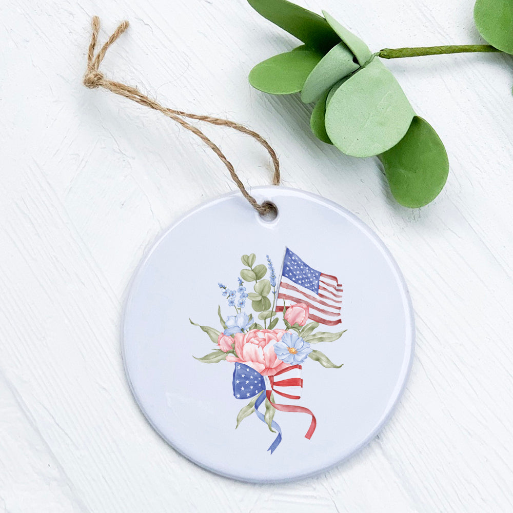 A beautifully crafted porcelain ornament featuring an American flag bouquet design, showcasing vibrant colors and a glossy finish.