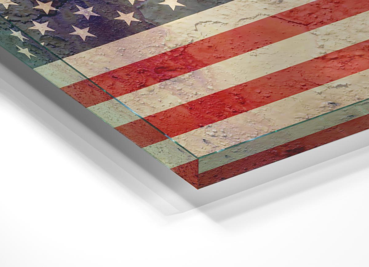 A modern glass print featuring a creatively cracked design of the American flag, showcasing vibrant colors and unique artistry.