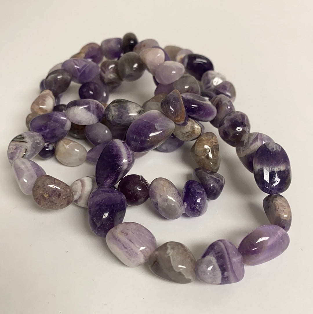 A beautifully polished Amethyst Bracelet featuring unique stones on an elastic band, radiating positive energy.