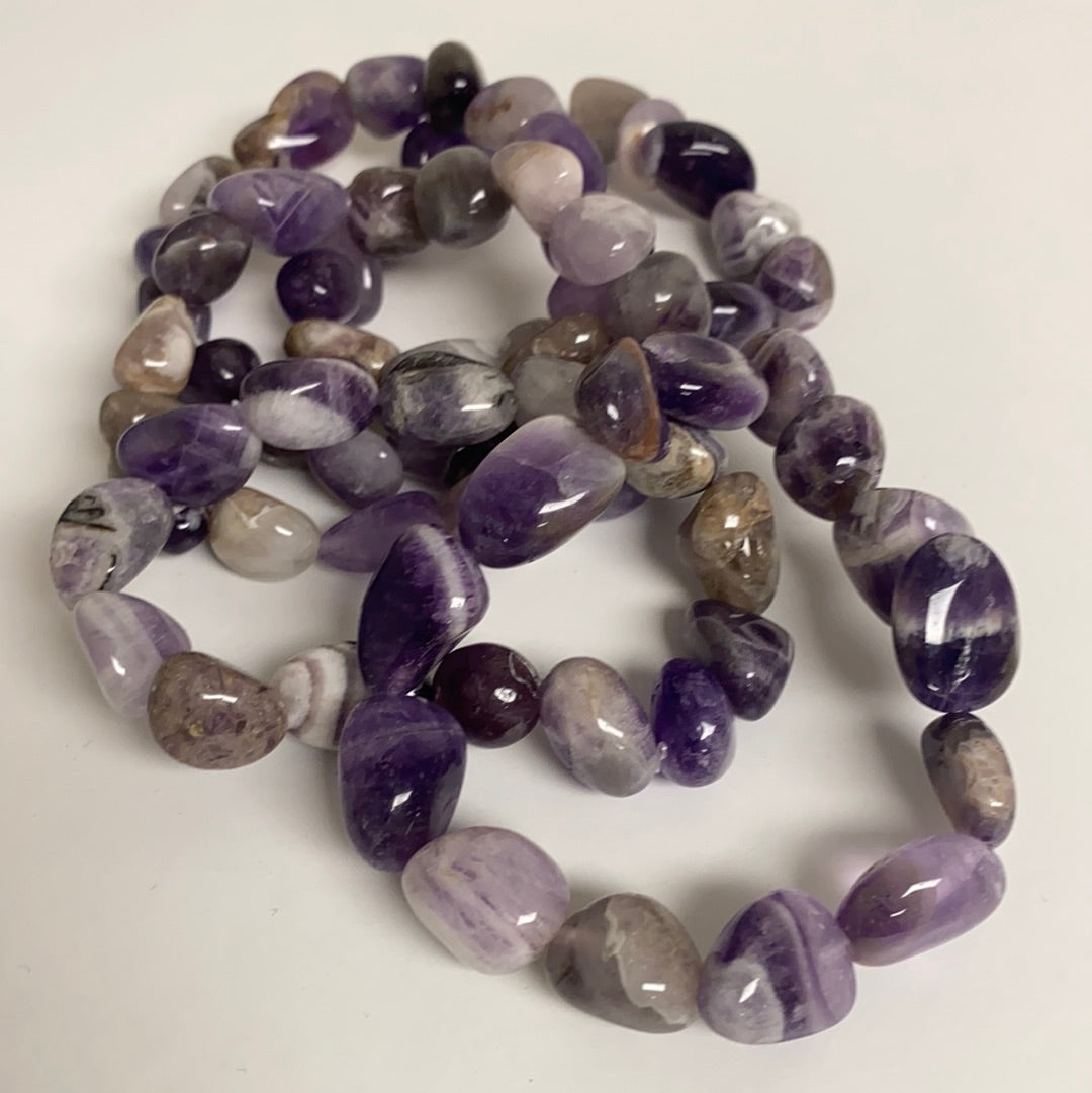 A beautifully polished Amethyst Bracelet featuring unique stones on an elastic band, radiating positive energy.