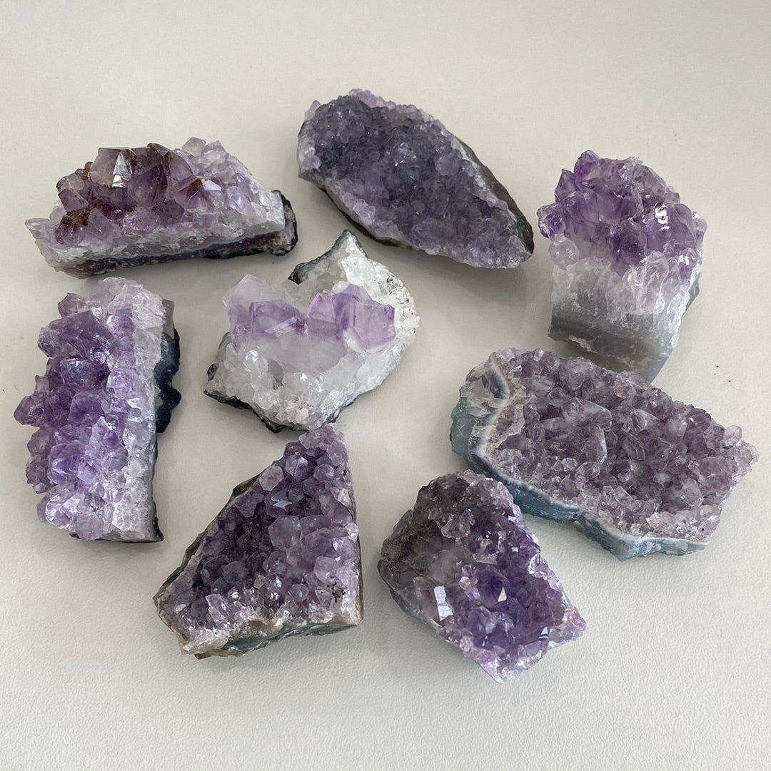 A collection of small amethyst clusters showcasing their unique purple hues and crystal formations.