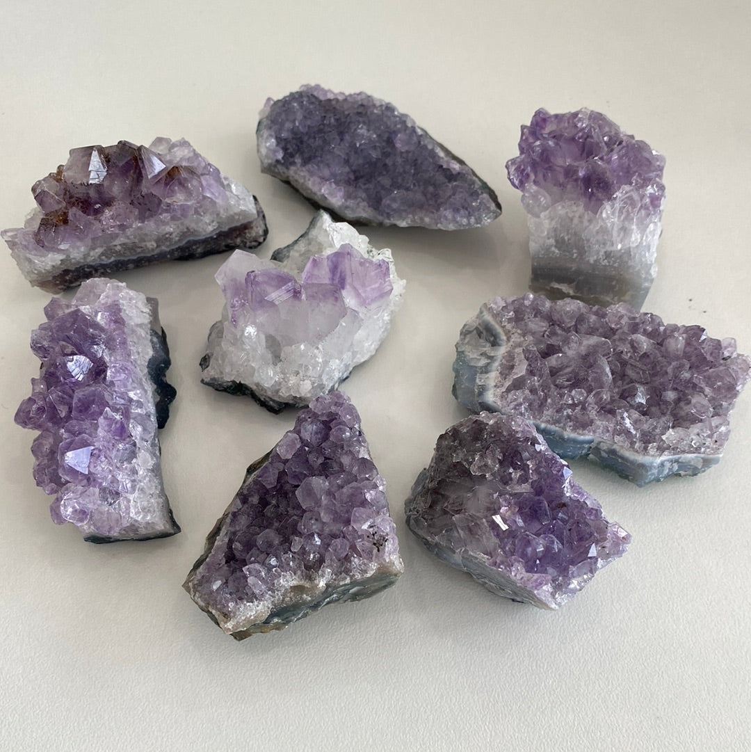 A collection of small amethyst clusters showcasing their unique purple hues and crystal formations.