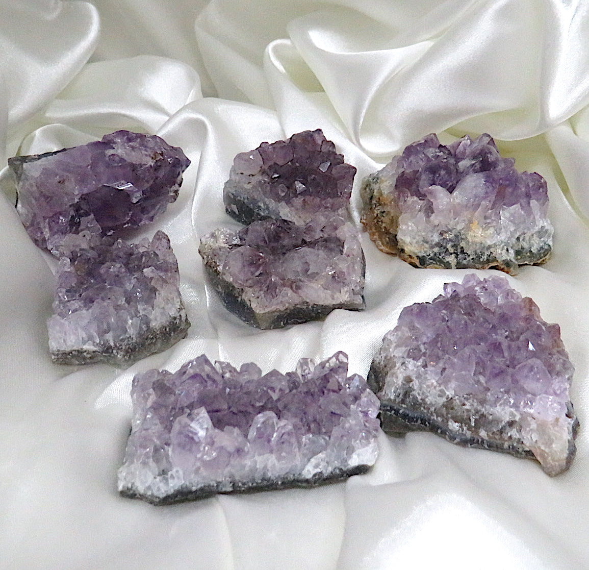 A stunning display of Amethyst Clusters showcasing deep purple hues and unique formations, perfect for healing and decoration.