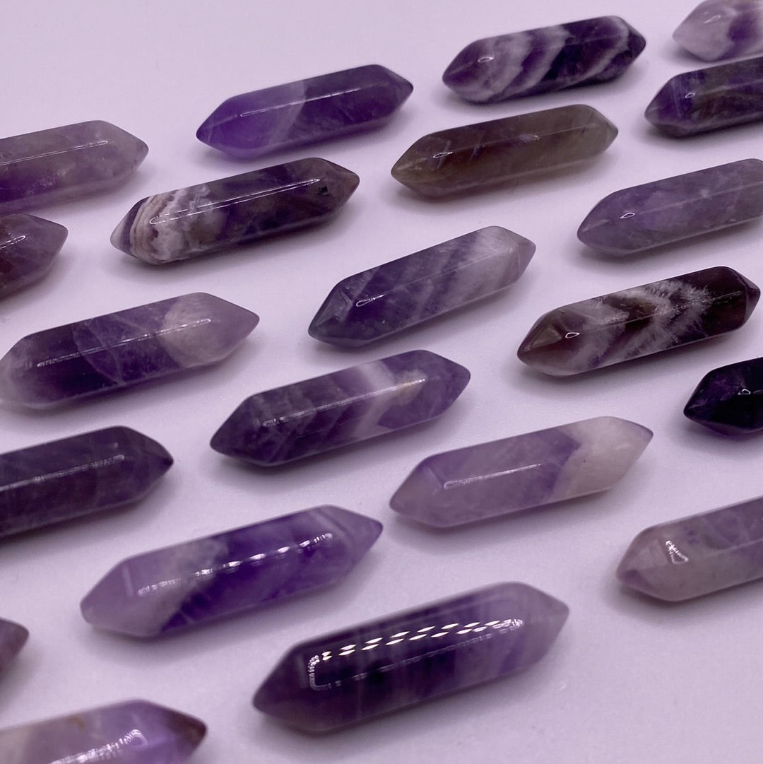 A small double terminated Amethyst crystal point showcasing rich purple hues, perfect for meditation and energy work.