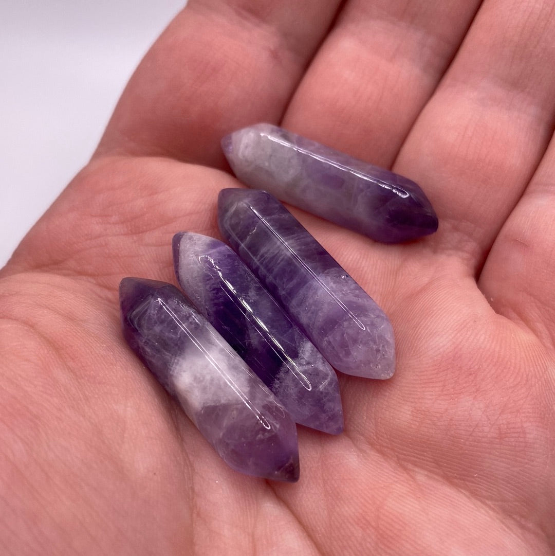 A small double terminated Amethyst crystal point showcasing rich purple hues, perfect for meditation and energy work.