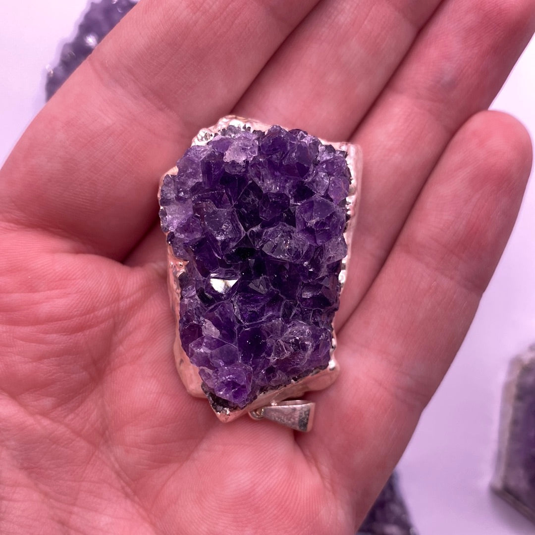 Amethyst Druzy Electroplated Pendant showcasing its vibrant purple hues and unique crystalline texture.