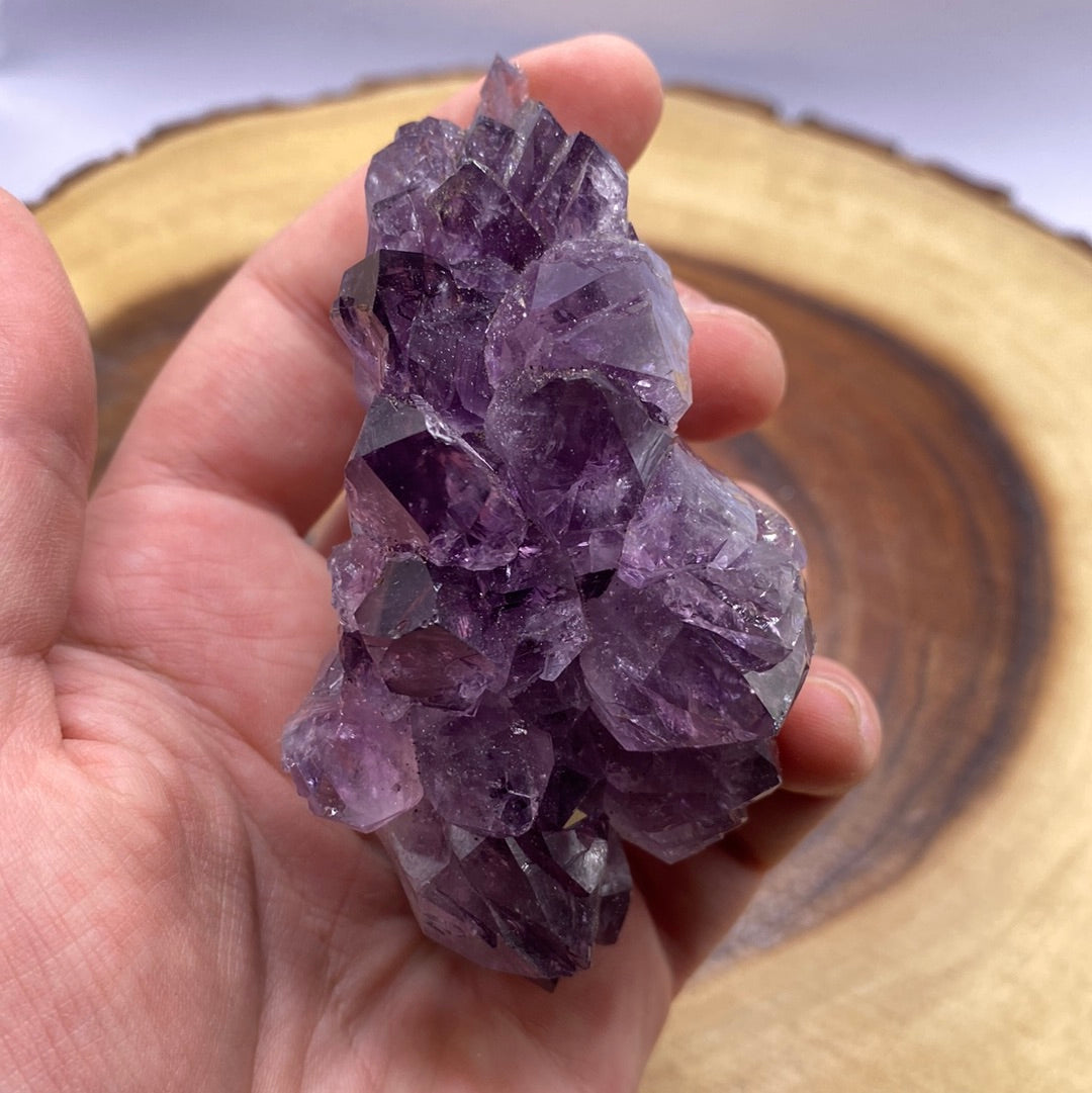 A beautiful Amethyst Druzy crystal cluster showcasing sparkling purple crystals on a rock base, radiating positive energy.