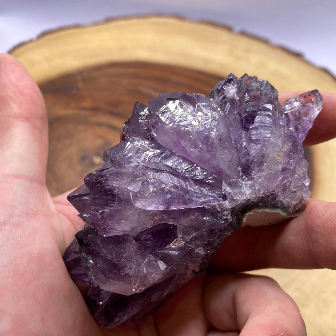 A beautiful Amethyst Druzy crystal cluster showcasing sparkling purple crystals on a rock base, radiating positive energy.