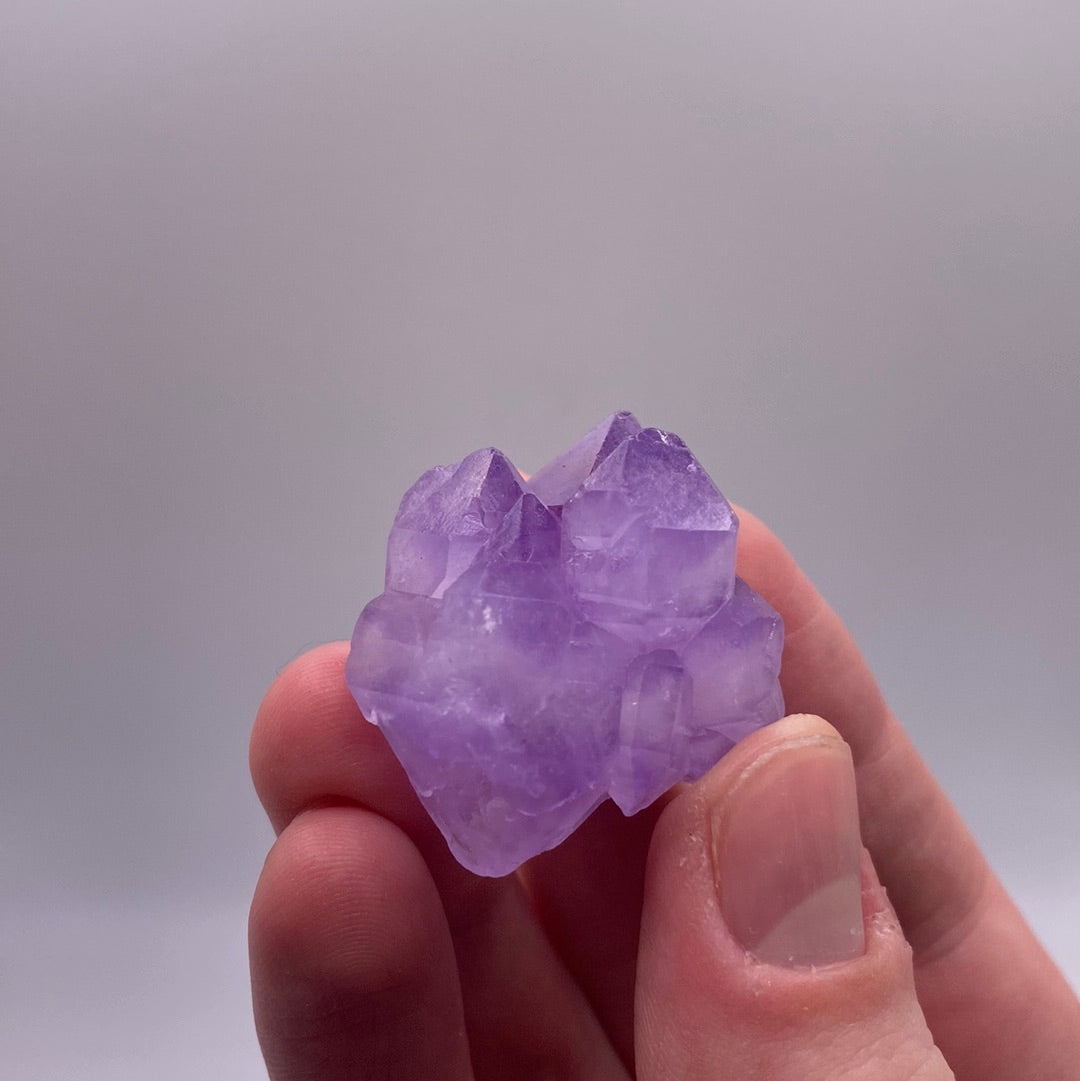 A collection of small amethyst clusters, showcasing various points and rich purple hues, perfect for decoration or healing.