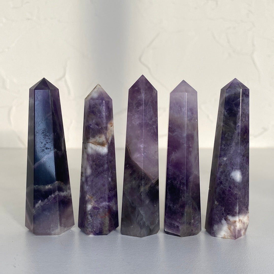 A beautiful 3-inch tall Amethyst Obelisk showcasing rich purple hues, unique shape, and ethically sourced from Brazil.