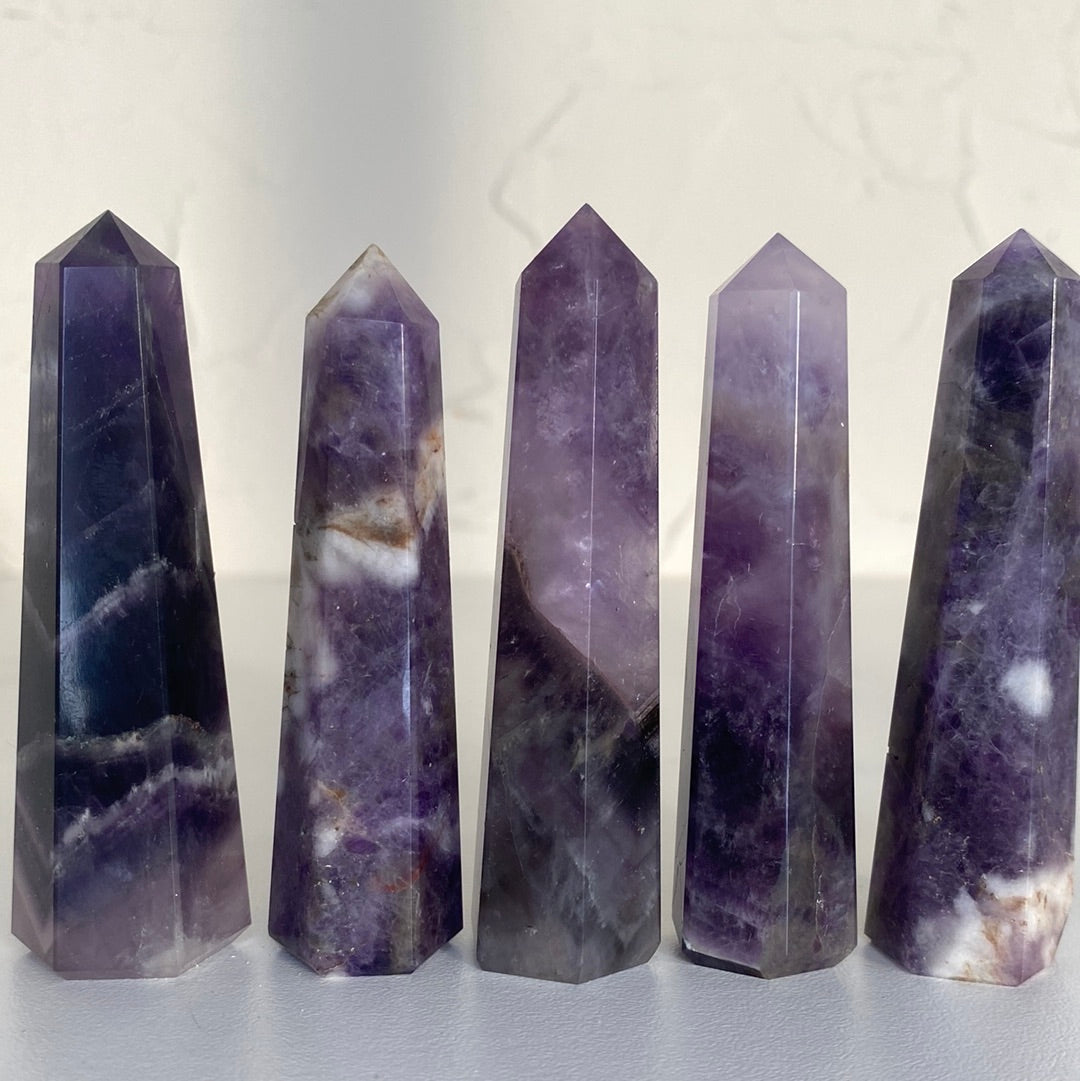 A beautiful 3-inch tall Amethyst Obelisk showcasing rich purple hues, unique shape, and ethically sourced from Brazil.