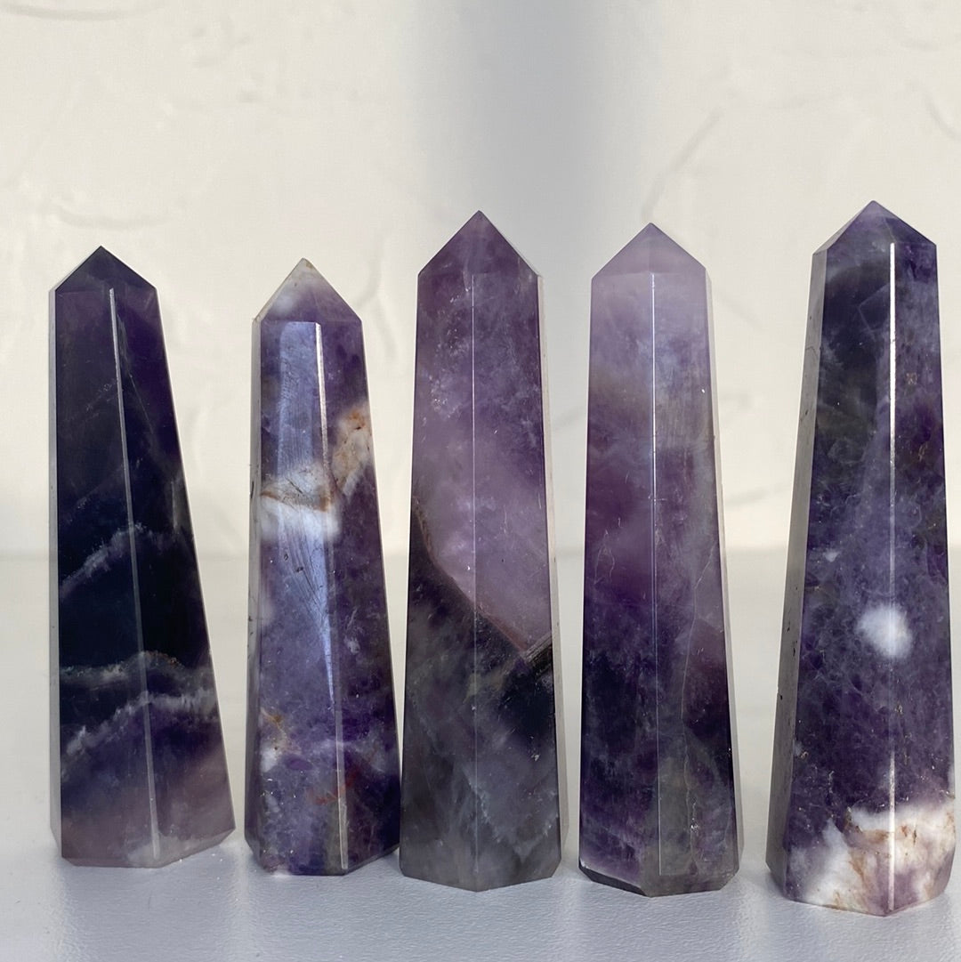 A beautiful 3-inch tall Amethyst Obelisk showcasing rich purple hues, unique shape, and ethically sourced from Brazil.