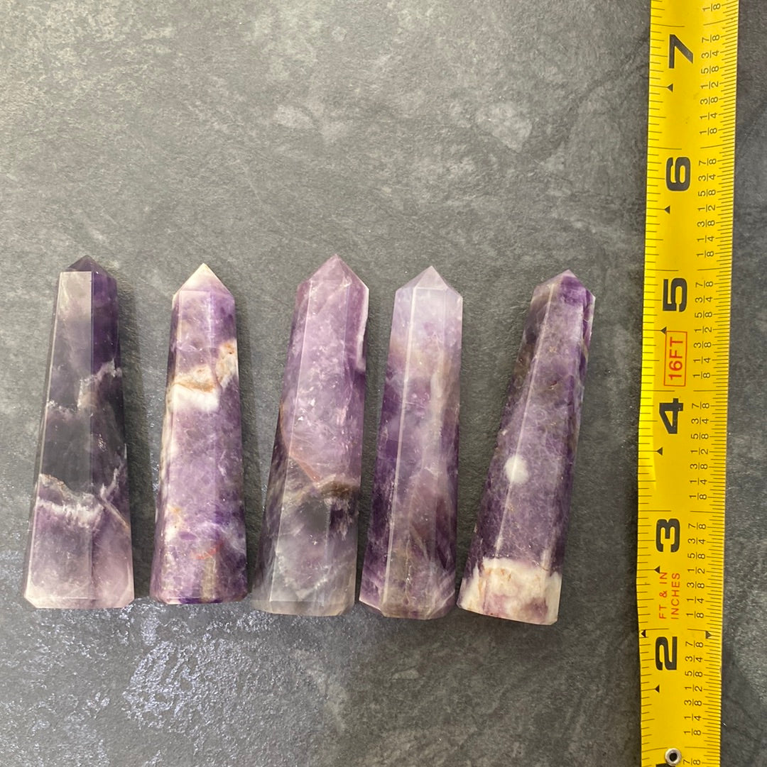 A beautiful 3-inch tall Amethyst Obelisk showcasing rich purple hues, unique shape, and ethically sourced from Brazil.