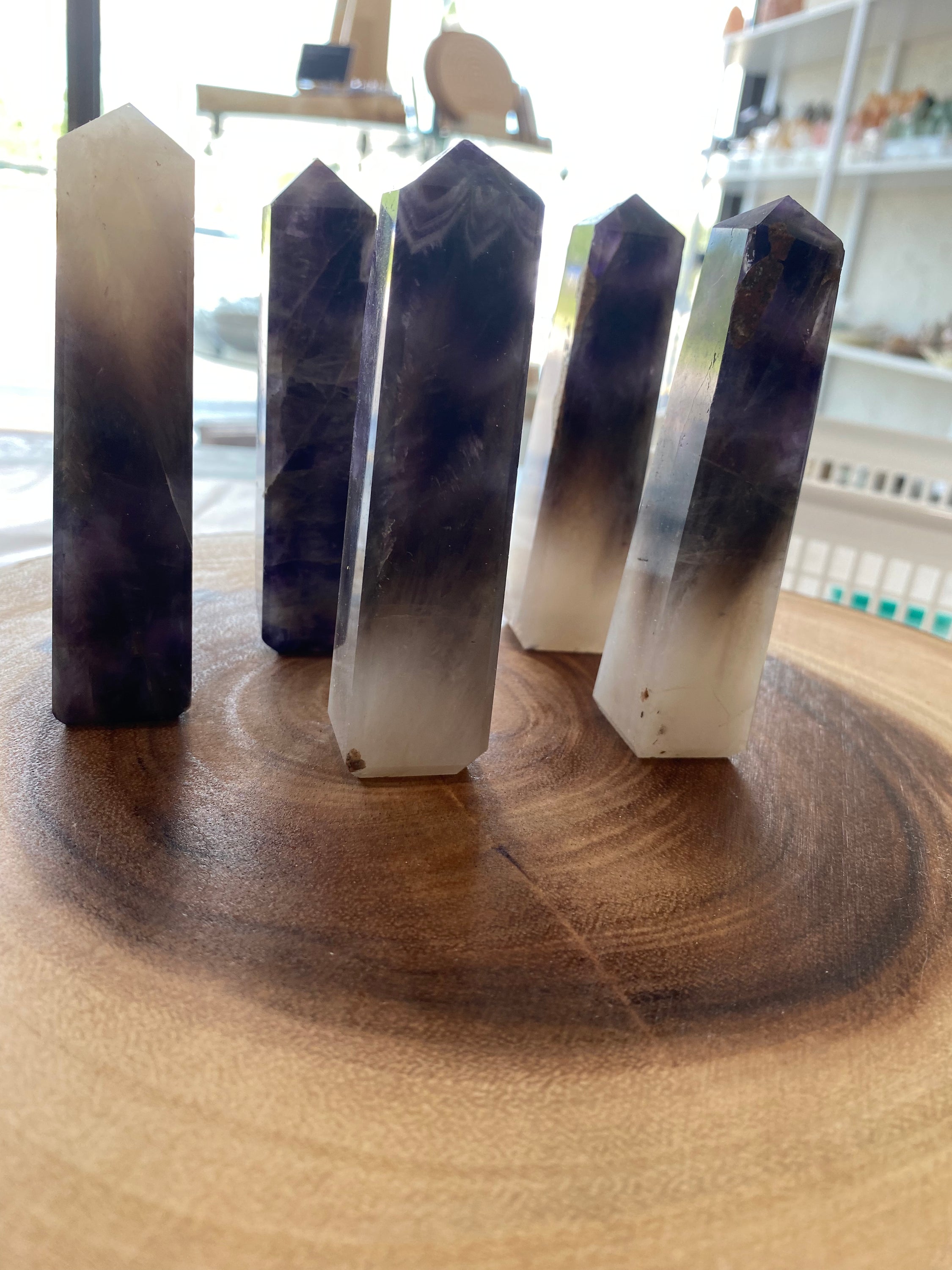 A stunning Amethyst Obelisk with a natural purple sheen, showcasing its hexagonal crystal structure and elegant design.