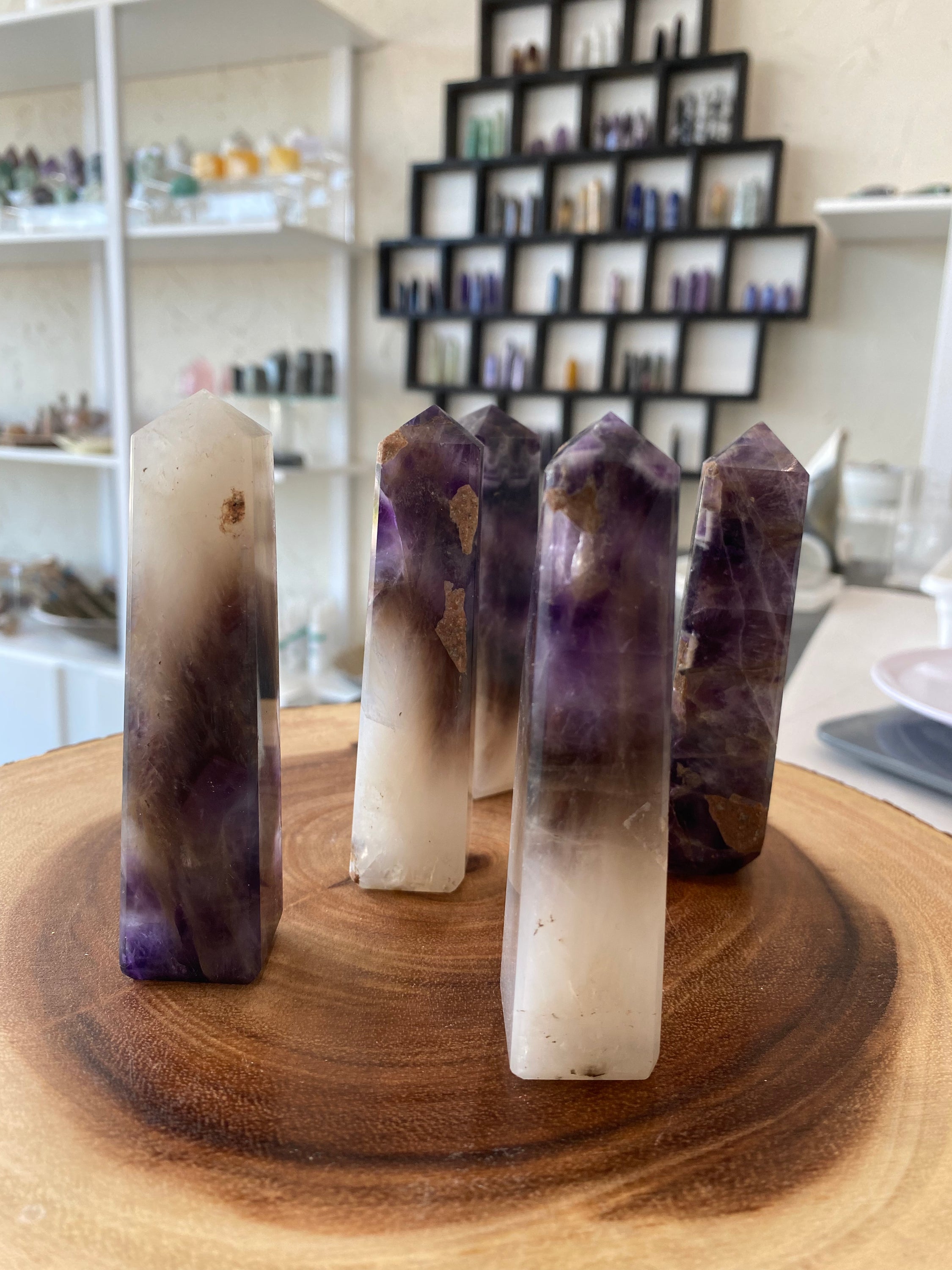 A stunning Amethyst Obelisk with a natural purple sheen, showcasing its hexagonal crystal structure and elegant design.