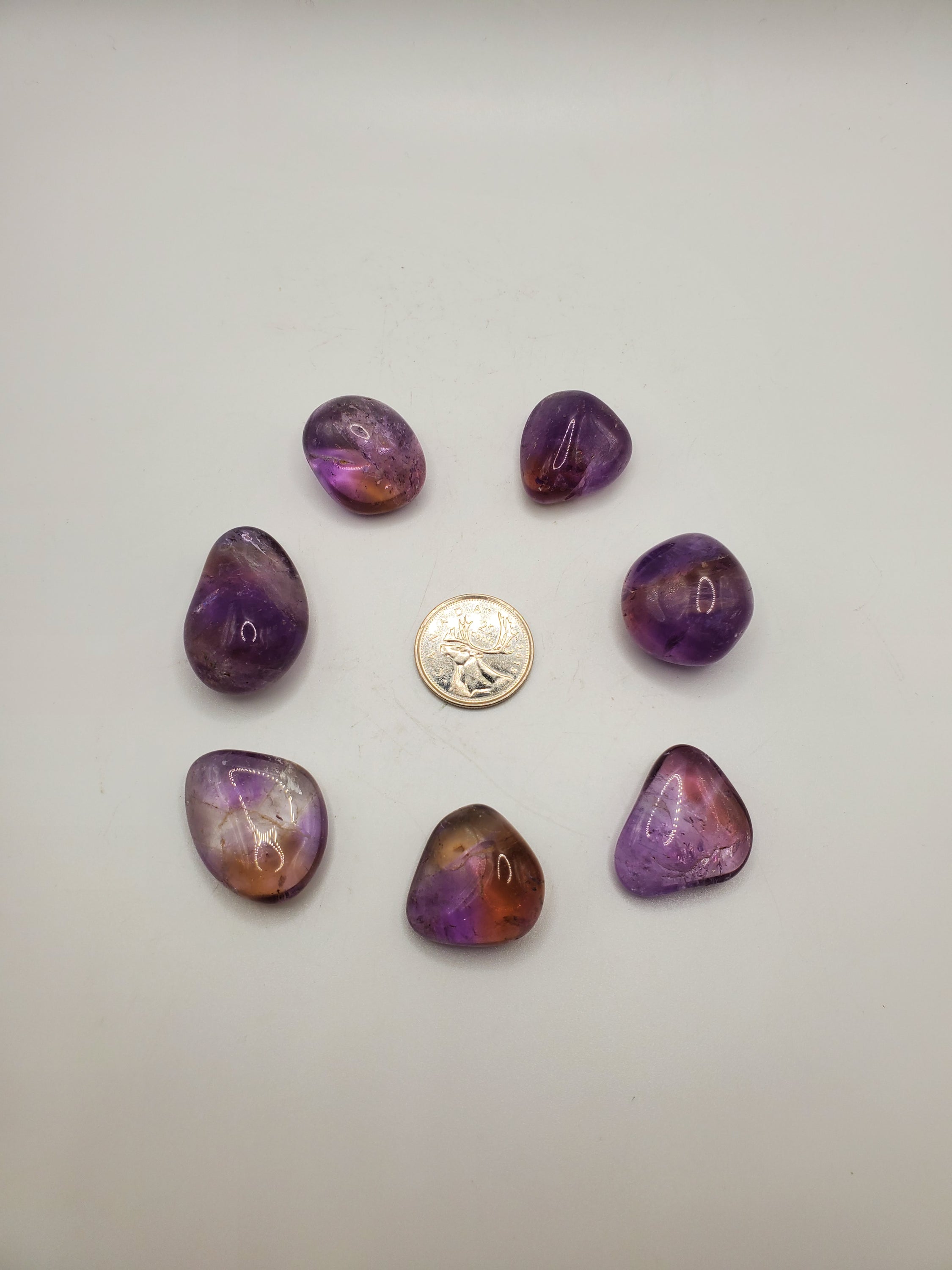 Ametrine Tumbled Stone showcasing its beautiful blend of purple Amethyst and yellow Citrine colors, polished and smooth.