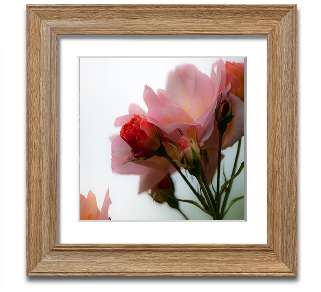 A square framed print featuring an array of vibrant pink flowers, elegantly displayed in a stylish frame.