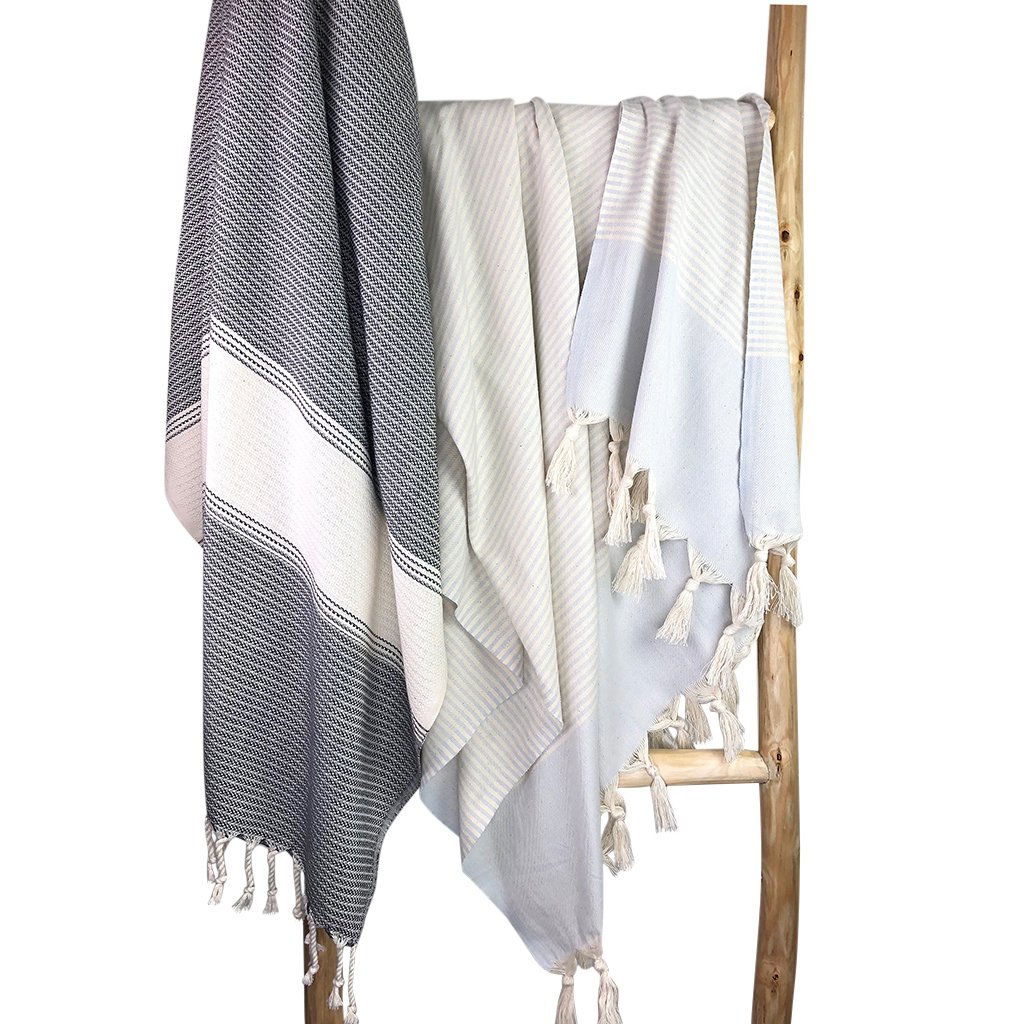 Anatolia Stripe Turkish Towel showcasing vibrant patterns and tassels, perfect for beach or bath use.