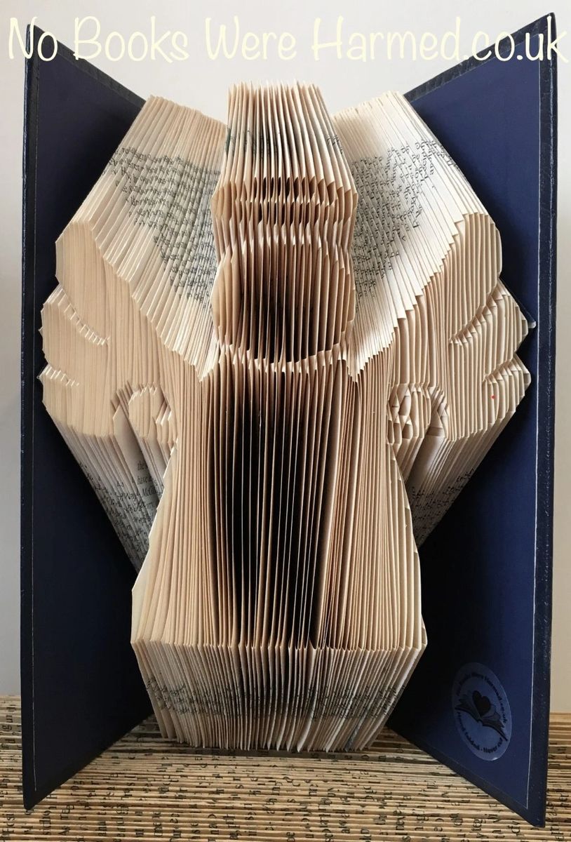 Handcrafted Book Angel art made from vintage books, showcasing intricate page folds and unique design.