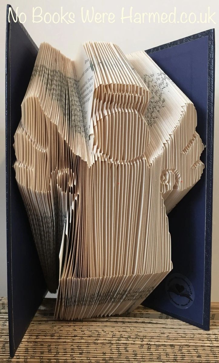 Handcrafted Book Angel art made from vintage books, showcasing intricate page folds and unique design.