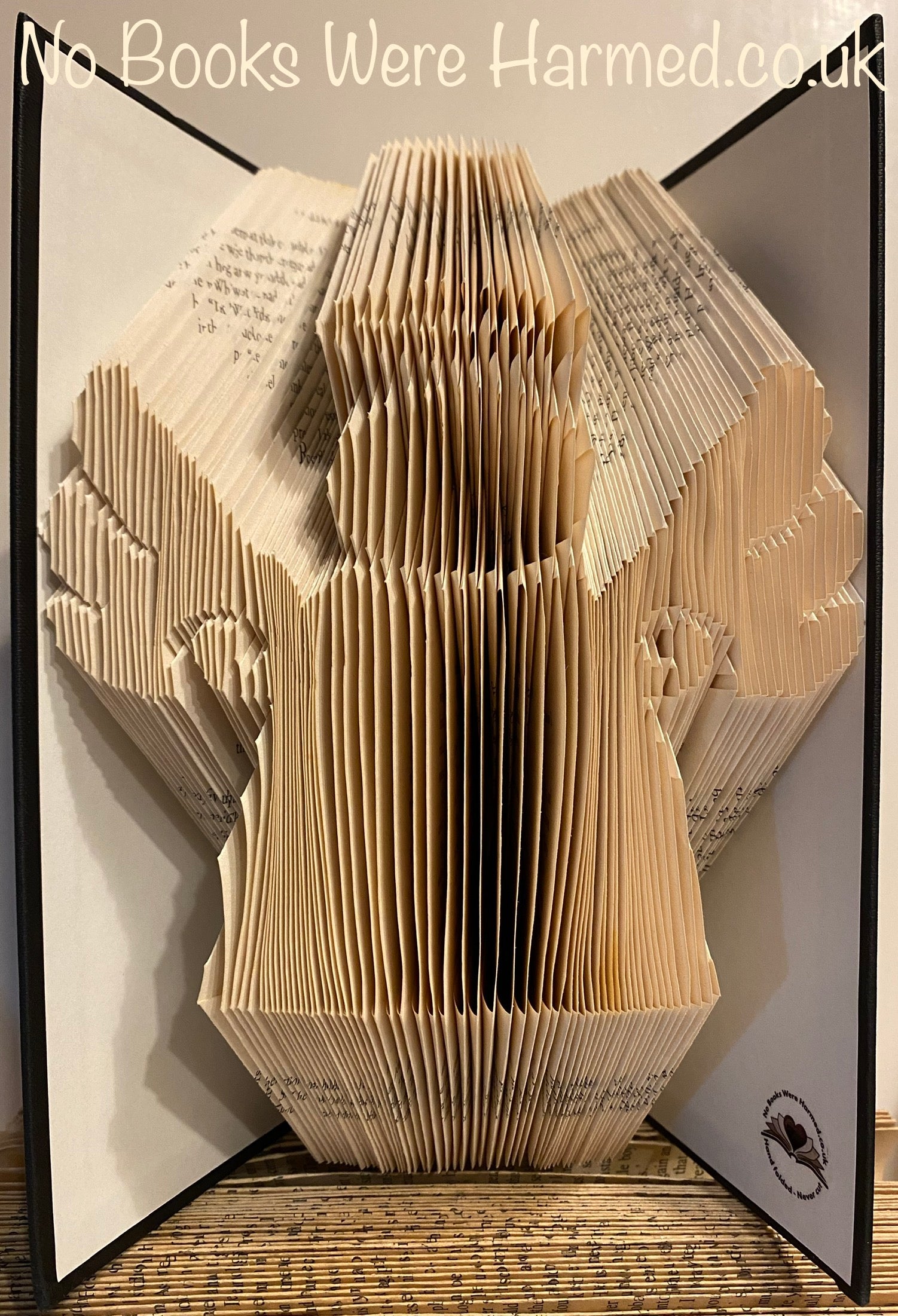 Handcrafted Book Angel art made from vintage books, showcasing intricate page folds and unique design.