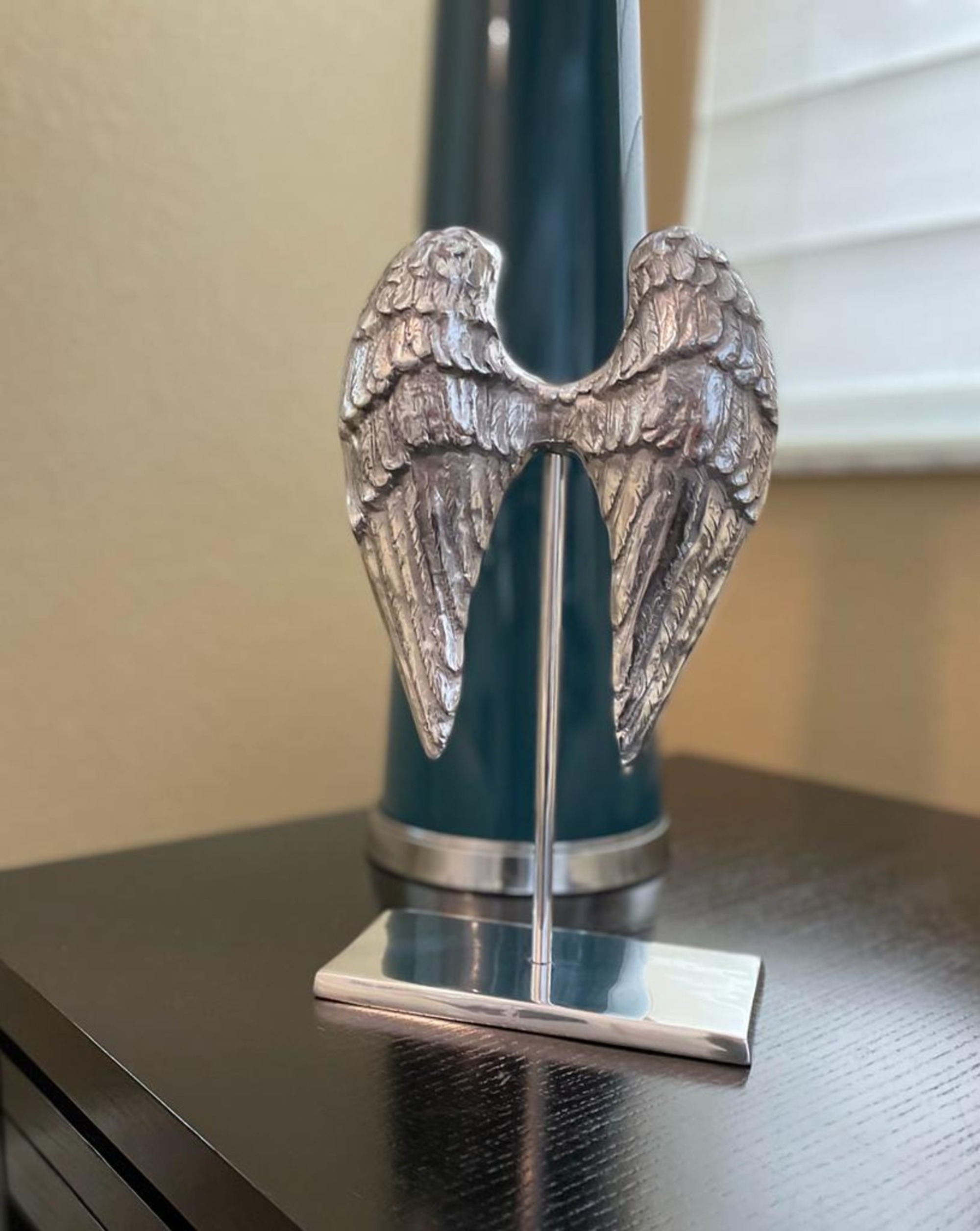 Elegant silvery angel wings sculpture made from recycled aluminum, perfect for modern home decor.