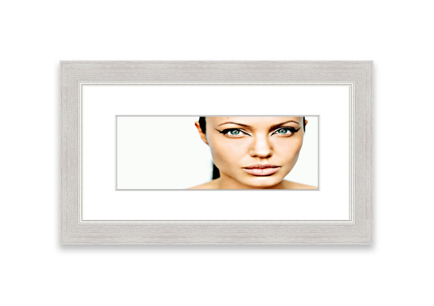 Framed print of Angelina Jolie with cat-like eyes, showcasing her iconic features in a stylish frame.