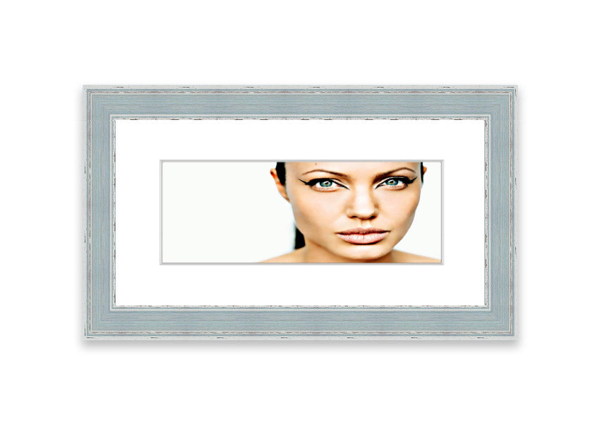 Framed print of Angelina Jolie with cat-like eyes, showcasing her iconic features in a stylish frame.