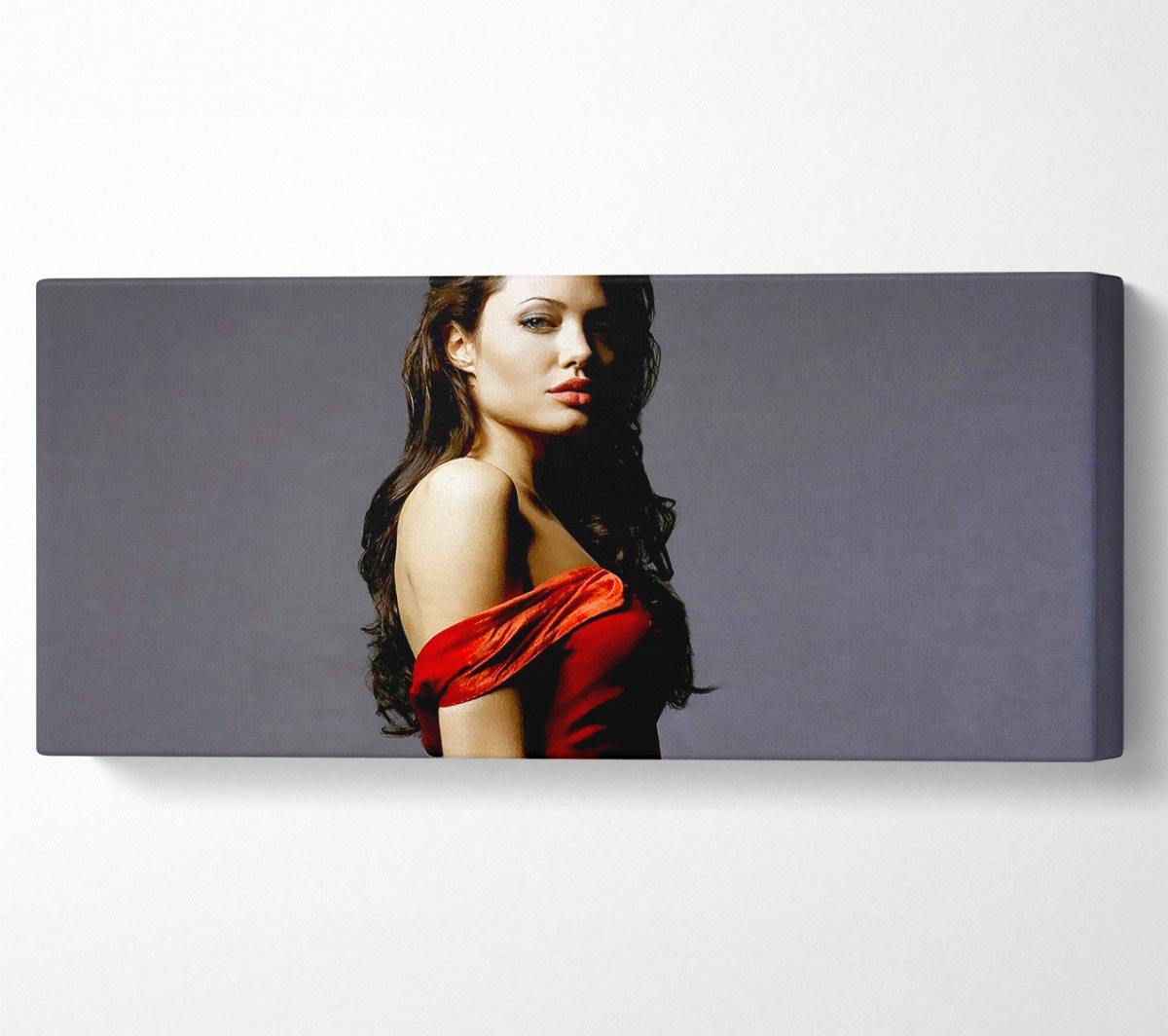 Canvas art featuring Angelina Jolie in a vibrant red dress, mounted on a sturdy box frame, ready to hang.