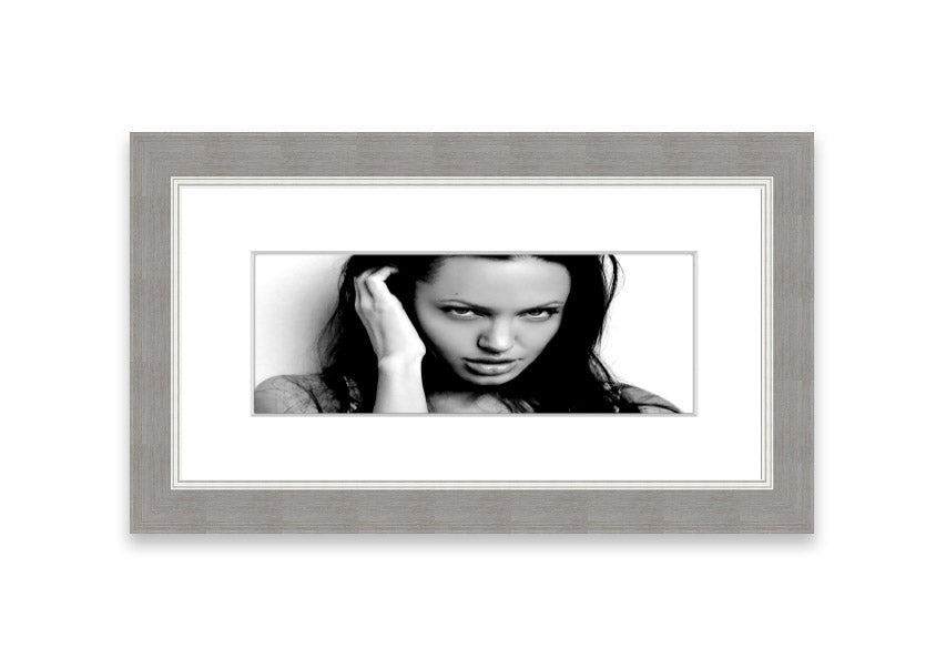 Framed print of Angelina Jolie with captivating eyes, available in various frame colors, handmade in the UK.