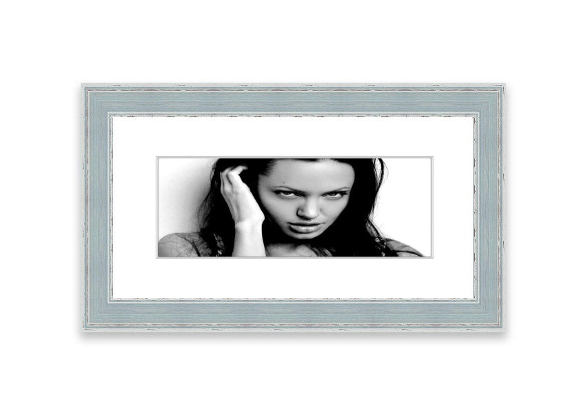 Framed print of Angelina Jolie with captivating eyes, available in various frame colors, handmade in the UK.