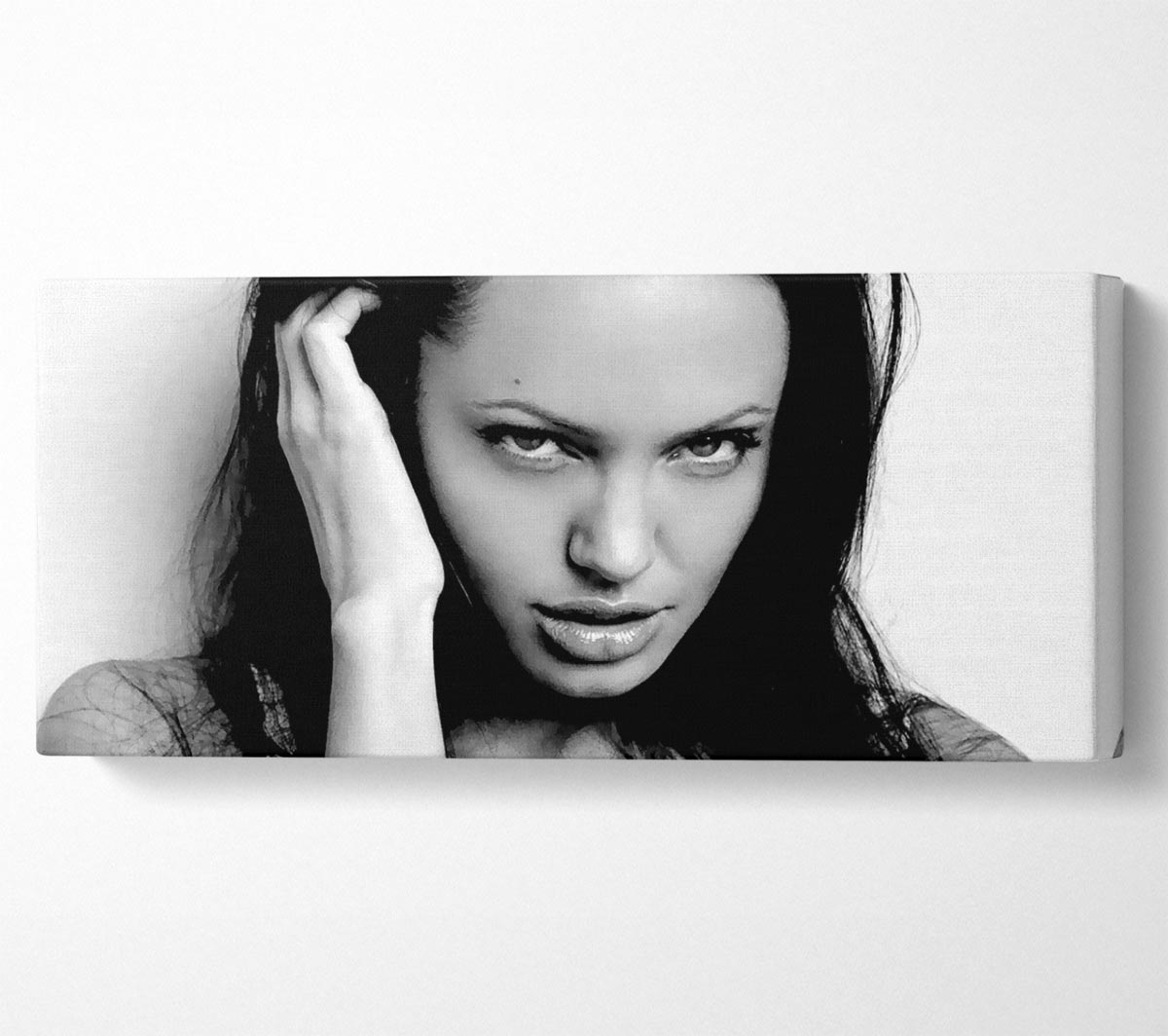 Canvas art featuring Angelina Jolie's captivating eyes, mounted on a sturdy box frame, ready to hang.