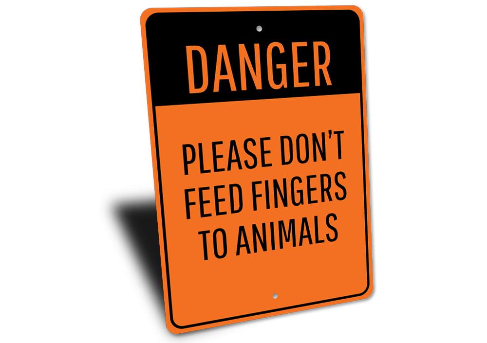 Animal Feeding Warning Sign made of durable aluminum, featuring clear warning text and pre-drilled holes for easy mounting.