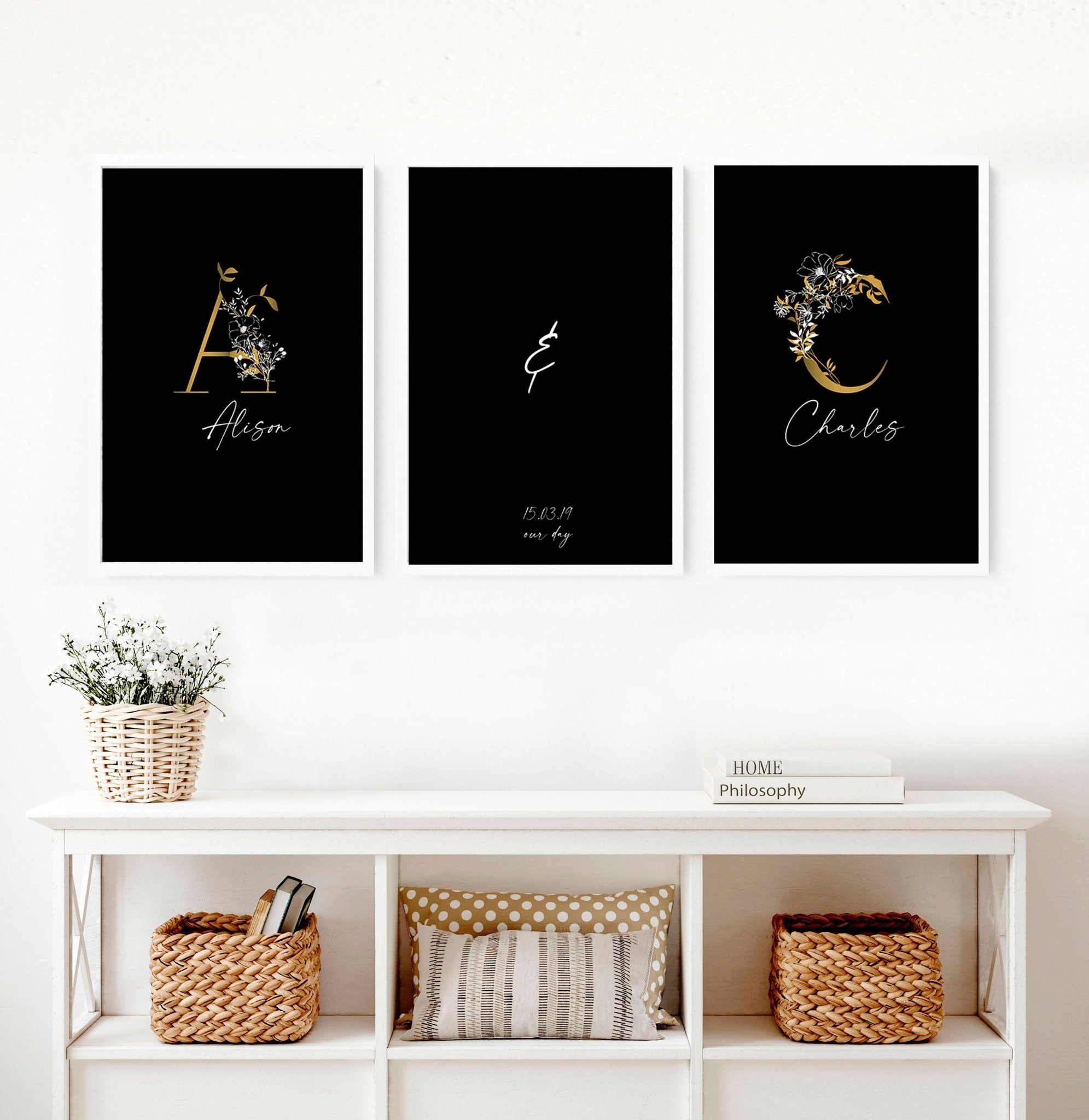 Set of 3 personalized wall art prints featuring botanical monogram designs in white, black, and gold on a black background.