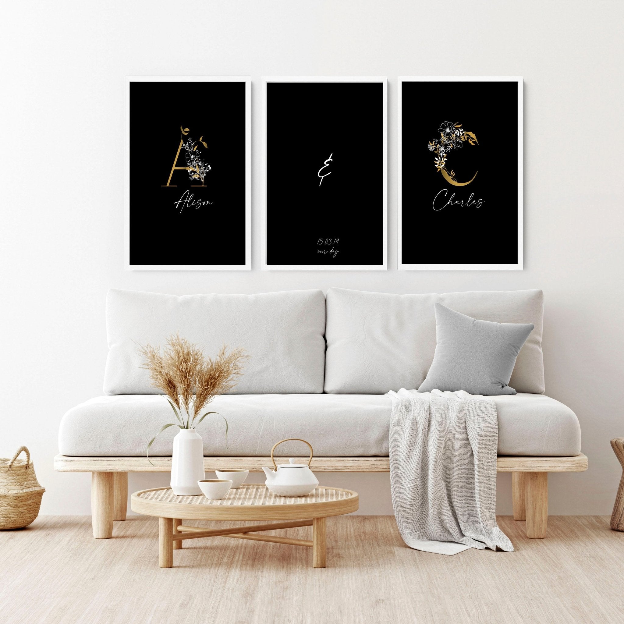 Set of 3 personalized wall art prints featuring botanical monogram designs in white, black, and gold on a black background.