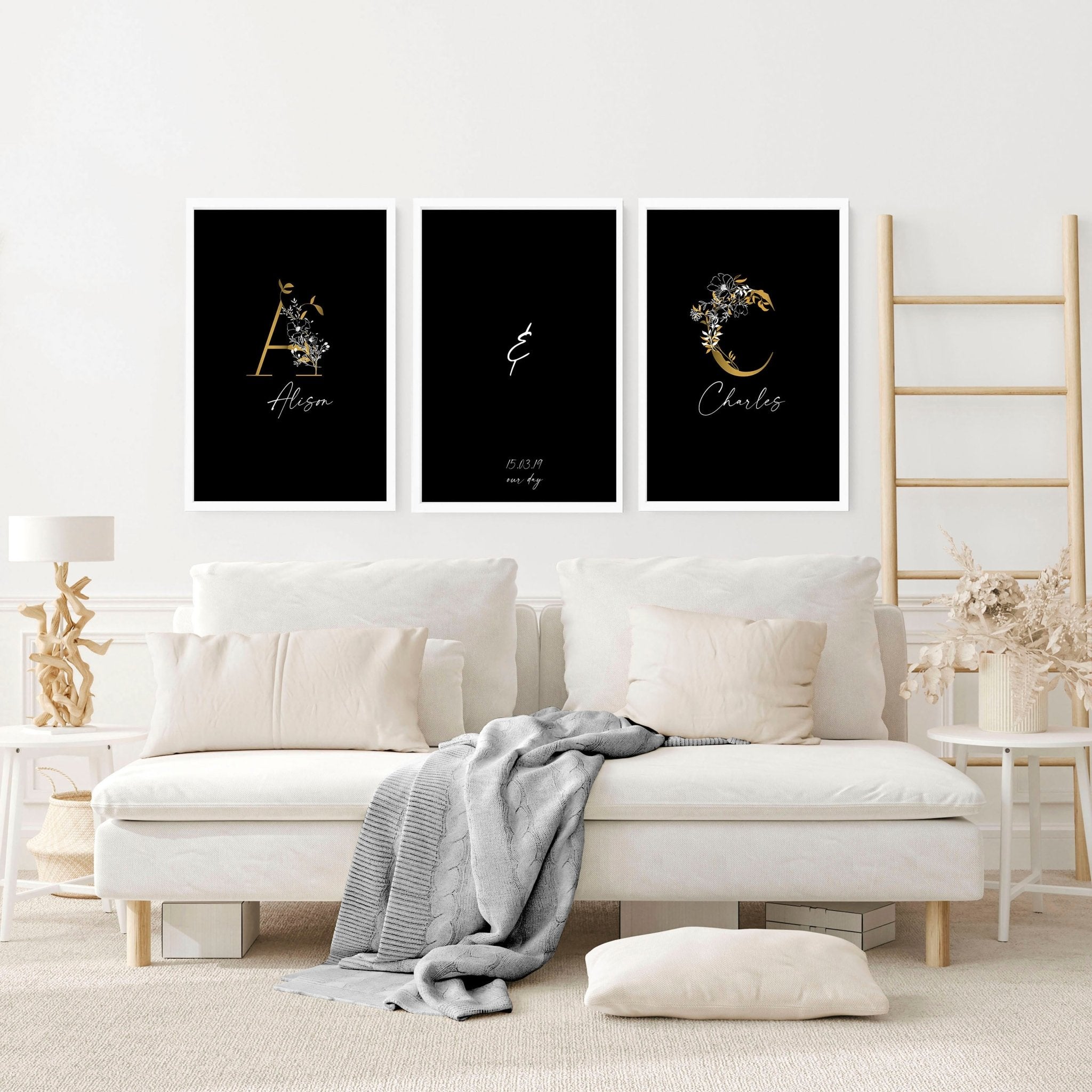 Set of 3 personalized wall art prints featuring botanical monogram designs in white, black, and gold on a black background.