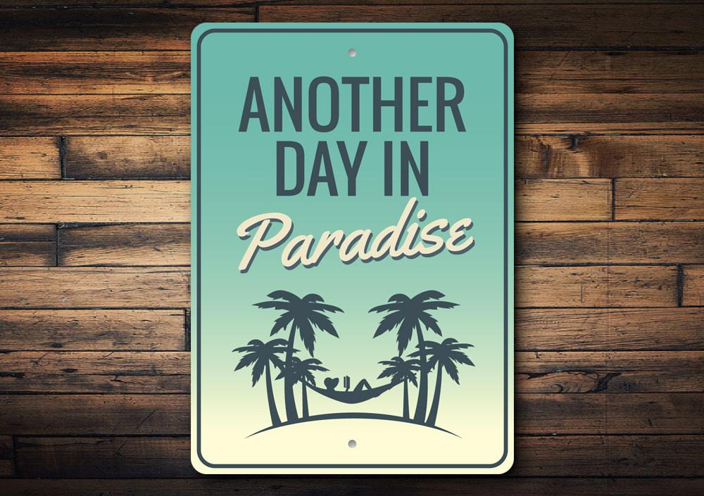 Another Day in Paradise decorative sign made of aluminum, featuring vibrant colors and beach-themed design, perfect for coastal decor.