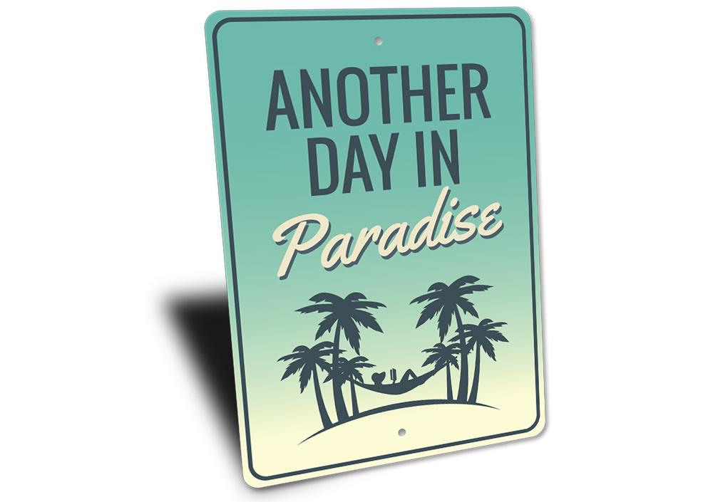 Another Day in Paradise decorative sign made of aluminum, featuring vibrant colors and beach-themed design, perfect for coastal decor.