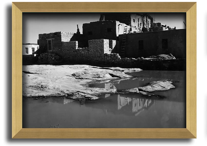 Framed print of Ansel Adams' Acoma Pueblo 3, showcasing intricate adobe structures and dramatic sky.