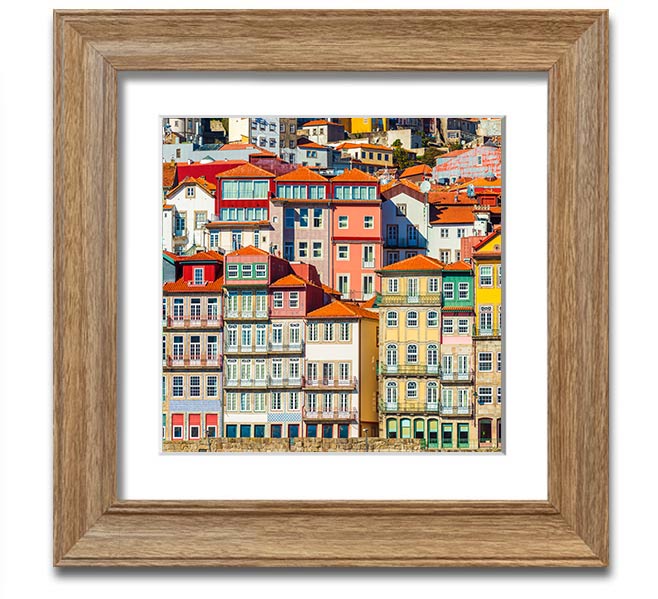 A beautifully framed print of coastal apartments, showcasing vibrant colors and intricate details, ready to hang on the wall.