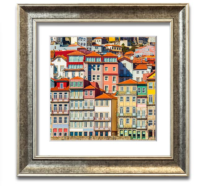 A beautifully framed print of coastal apartments, showcasing vibrant colors and intricate details, ready to hang on the wall.