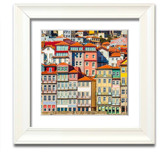 A beautifully framed print of coastal apartments, showcasing vibrant colors and intricate details, ready to hang on the wall.